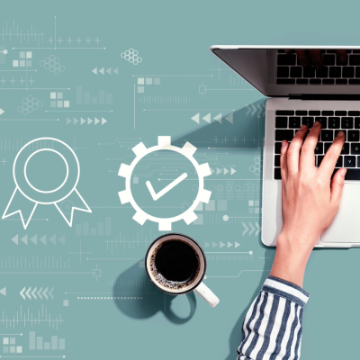 Office worker using a laptop with coffee